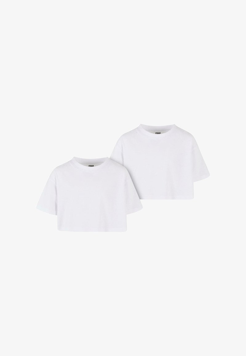Camisetas blancas recortadas con mangas cortas, cuellos redondos y una textura suave. Cada camiseta presenta un diseño minimalista sin patrones.