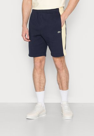 UNISEX - Tracksuit bottoms - marine/jaune