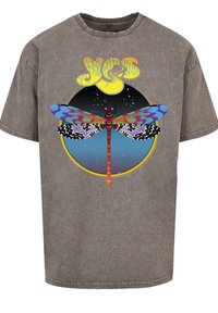 Gray vintage-style T-shirt featuring a colorful dragonfly graphic with a round yellow and blue background and stylized text above.