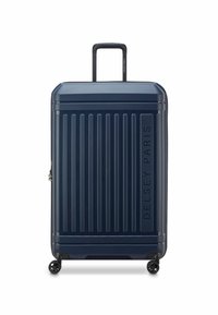 Valigia rigida a rotelle di colore blu navy, con linee verticali, manico telescopico, quattro ruote e marchio in rilievo "DELSY PARIS".