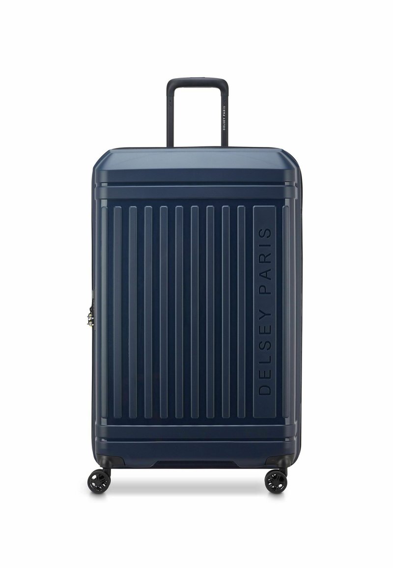 Valigia rigida a rotelle di colore blu navy, con linee verticali, manico telescopico, quattro ruote e marchio in rilievo "DELSY PARIS".
