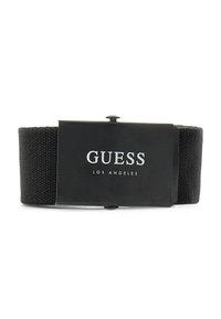Sort vævet stofbælte med en glat tekstur og en mærket metalspænde, der har "GUESS LOS ANGELES" i fede sølvbogstaver.