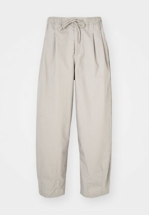 Beige, lightweight trousers with an elastic waistband and drawstring. Features pleats and a loose fit, crafted from soft, smooth fabric.