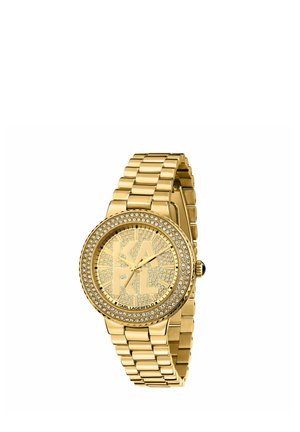 Orologio da polso in oro con grandi lettere KRAL sul quadrante tempestato di cristalli, lunetta in cristallo e cinturino metallico a maglie, di Karl Lagerfeld.