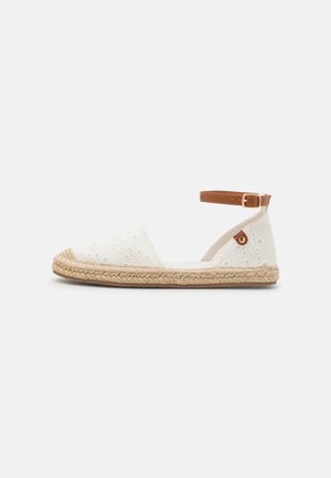 White canvas espadrille with floral embroidery, jute sole, and brown ankle strap. Features rounded toe and textured surface.