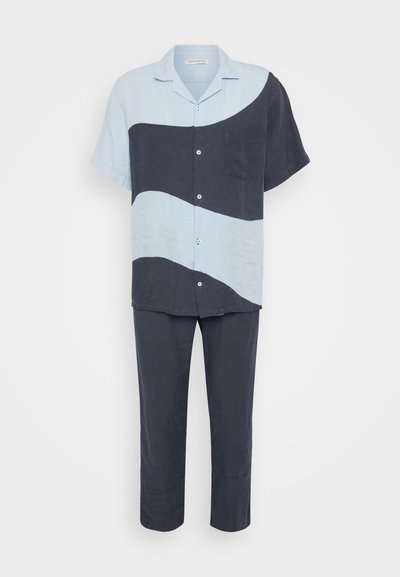 Linen two-piece set featuring a light blue short-sleeve shirt with dark blue wave pattern and matching dark blue pants.