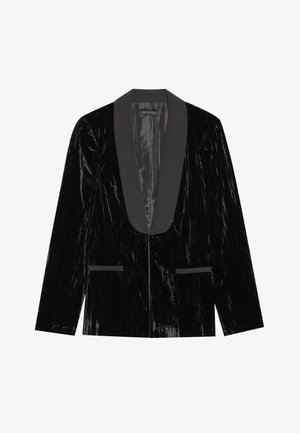Black velvet blazer with a satin shawl collar, featuring front pockets and a textured surface, creating a sleek and formal appearance.