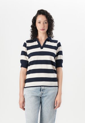 Gestreiftes Poloshirt in Marineblau und Creme, mit V-Ausschnitt, kurzen puffigen Ärmeln und einem lockeren Schnitt. Hergestellt aus einer weichen Baumwollmischung.