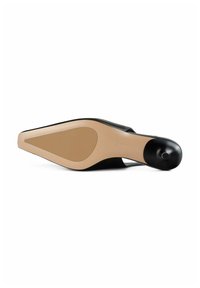 Black high-heeled shoe with a pointed toe and a nude rubber sole. Features a sleek design with a smooth texture and minimal accents.