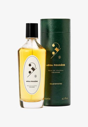 Bouteille en verre transparent avec un bouchon noir, contenant un parfum jaune. Étiquette blanche avec un texte noir. Boîte cylindrique verte avec des accents dorés. 125ml.