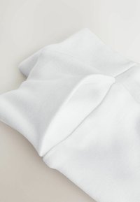 Witte katoenen stof, gevouwen met geribbelde textuur aan de randen, glad oppervlak, subtiele glans, zonder zichtbare patronen of hardware.