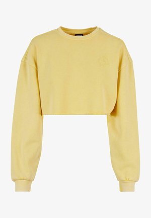 Sweatshirt court jaune avec des manches longues, des poignets côtelés et un subtil motif floral sur la poitrine. Fabriqué en tissu doux et texturé.