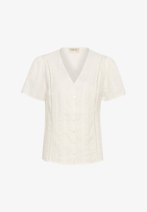Balta īsā piedurkne blūze ar V veida kakla izgriezumu, ar pogu aizdari priekšā un dekoratīvām viļņotām detaļām sānos.