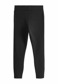 Fekete leggings, amely sima, rugalmas anyagból készült. A dizájn magasan ülő derékkal és testhezálló siluettel rendelkezik, látható varratok nélkül.