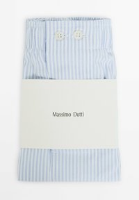 Blue and white striped dress shirt folded with a light beige label featuring "Massimo Dutti" in black text. Two buttons at the collar.