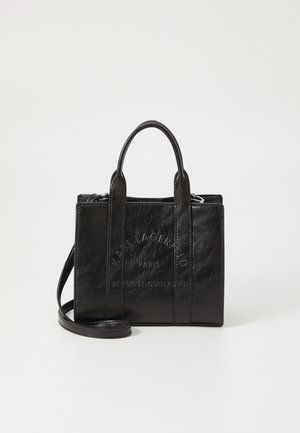 Black leather handbag with a textured finish, featuring embossed branding, two top handles, and a detachable shoulder strap.