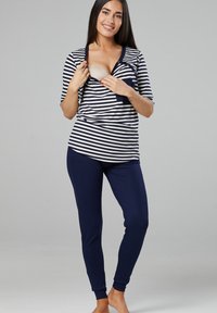 Striped nursing top in navy and white with button closure; paired with solid navy leggings. Comfortable fabric, relaxed fit, long sleeves.
