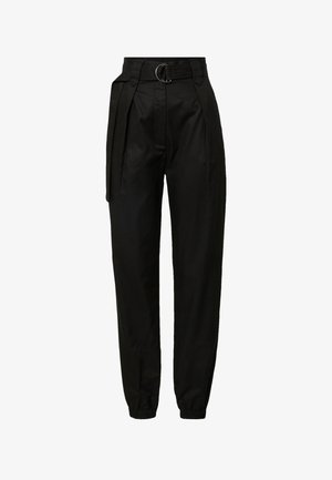 Black trousers with a high waist, featuring a circular belt buckle, pleats at the front, and elastic cuffs at the ankles. Smooth fabric texture.