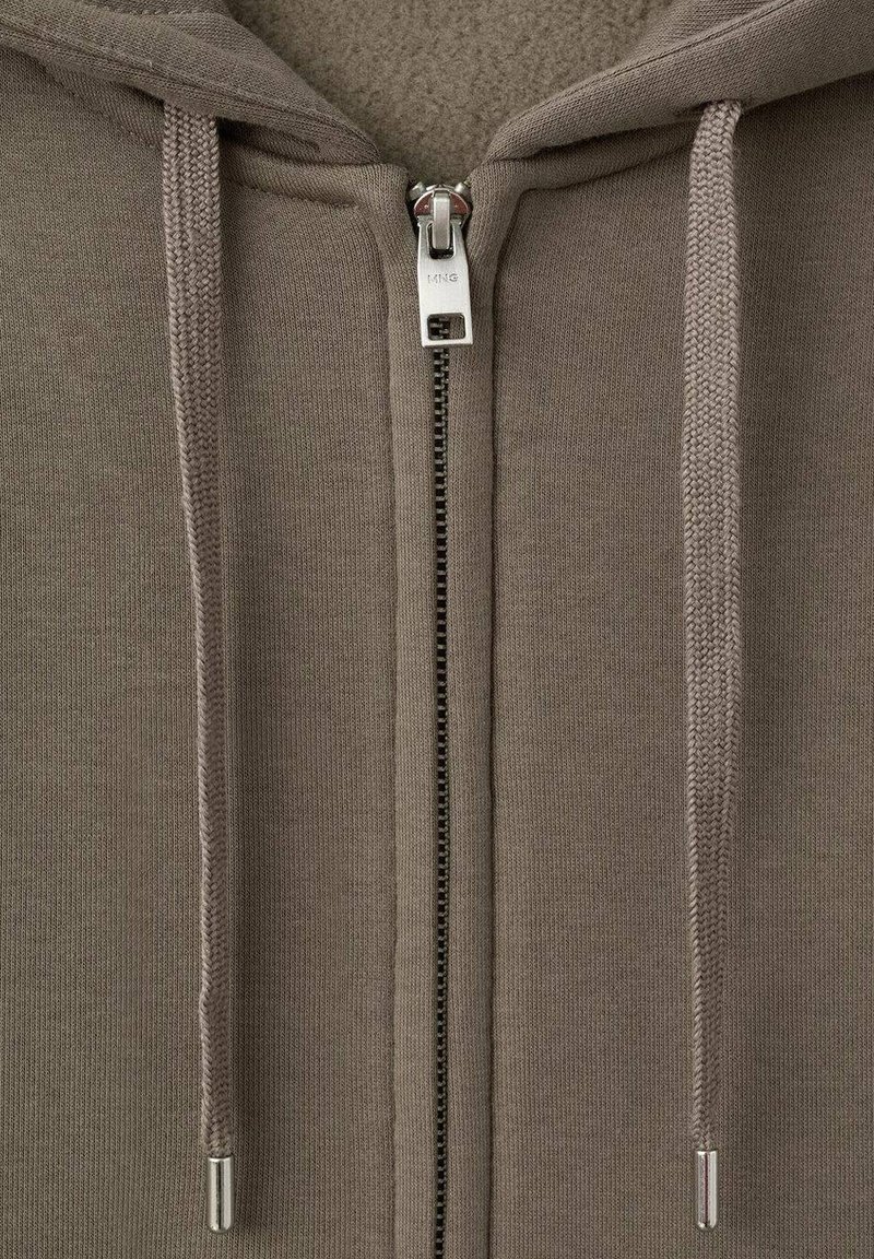 Brown zip-up hoodie with a fuzzy lining, featuring a silver zipper and two drawstrings. Material is soft and textured.