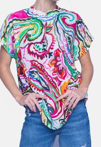 Värikäs, lyhythihainen paita, jossa on valkoinen tausta ja eloisat kukka- ja paisley-kuviot vaaleanpunaisena, vihreänä ja oranssina; pehmeä kangas, rento istuvuus.