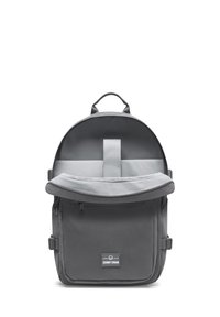 Rucsac gri cu partea superioară rotunjită, buzunar frontal cu fermoar și sistem de închidere cu clapetă. Fabricat dintr-un material durabil, cu un design simplu și funcțional.