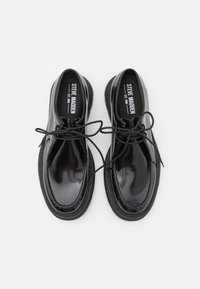 Black, polished leather dress shoes with round toe, lace-up design, and contrasting black sole detail. Smooth texture with minimal accents.