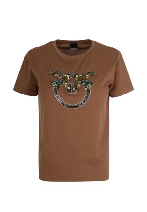 Hnedé tričko s krátkym rukávom s veľkým zdobeným motívom dvoch vtákov a dekoratívnymi drahokamami na hrudi.