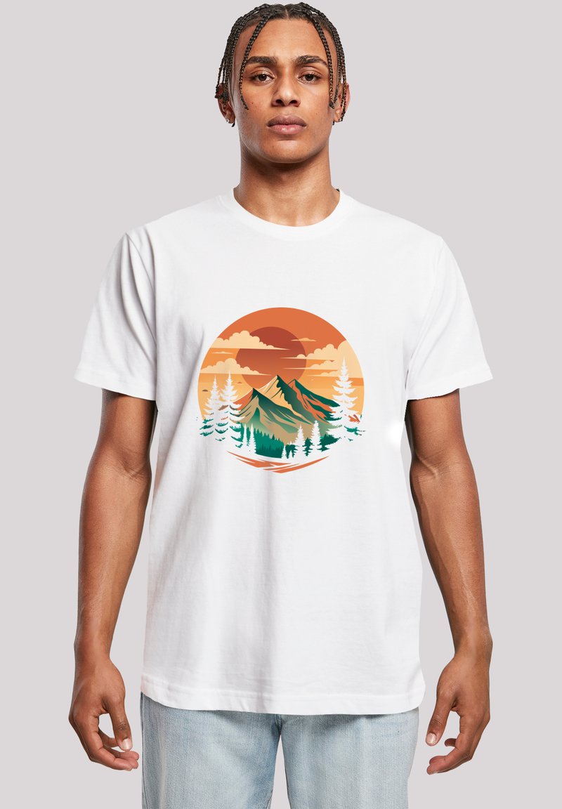 White cotton t-shirt featuring a colorful graphic of mountains and trees against a sunset in shades of orange, green, and blue.
