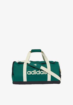 Borsa da viaggio verde Adidas con cinghie bianche, base nera, tasca laterale con zip e tracolla regolabile con impugnatura imbottita.