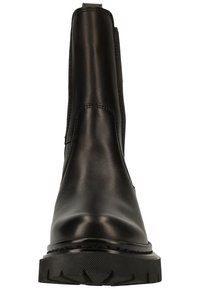 Black leather ankle boot with a rounded toe, elastic side panels, and a textured rubber sole for grip. Minimalist design, no visible hardware.