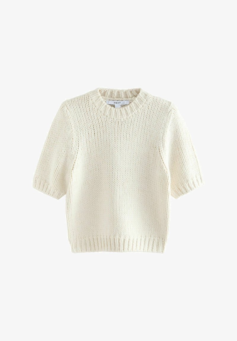 Pull crème à manches courtes avec un col rond, texture tricotée et détails de ourlet côtelé. Fabriqué en matériau de fil doux.