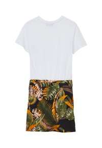 Abito a maniche corte: parte superiore in cotone bianco con una gonna in tessuto nero decorata con grandi motivi di foglie tropicali verdi e arancioni.