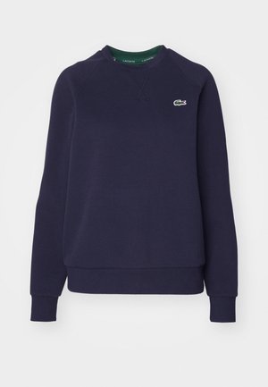 Navyblauwe sweatshirt van katoen, met een ronde hals, geribbelde manchetten en een klein groen Lacoste-logo op de borst.