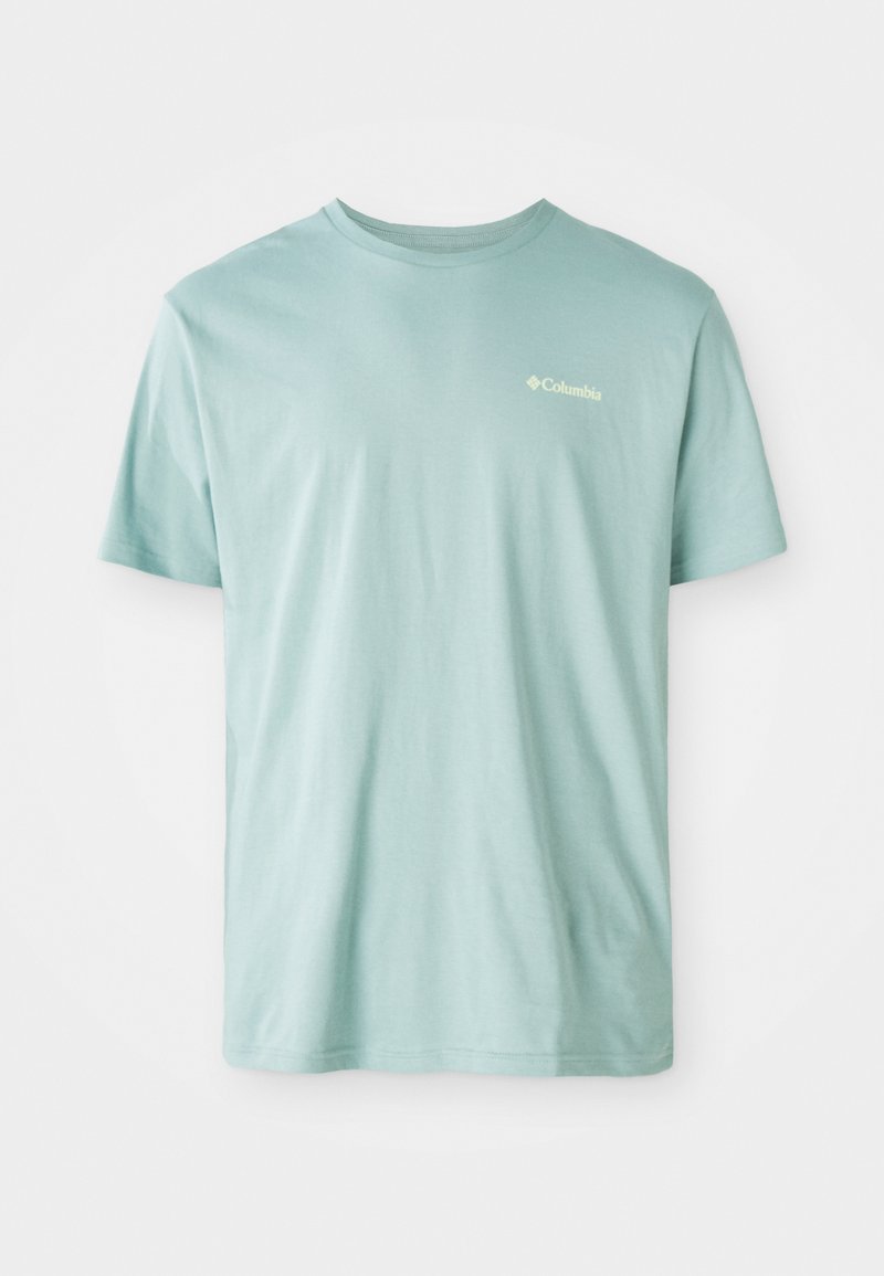 T-shirt en coton bleu clair à manches courtes, col rond, avec un petit logo blanc sur la poitrine. Texture douce, coupe décontractée.