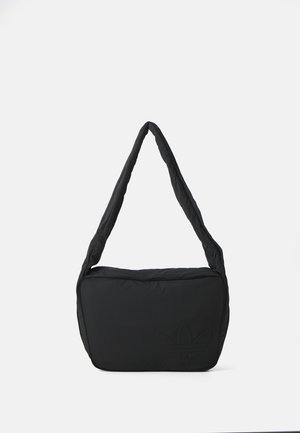 Black shoulder bag with a padded texture, a rounded shape, and a wide strap, featuring an embossed logo on the front.