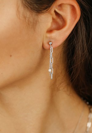 Silver dangle earrings featuring a chain design with cut-out rectangular links and a small pearl accent at the bottom, showcasing a layered effect.