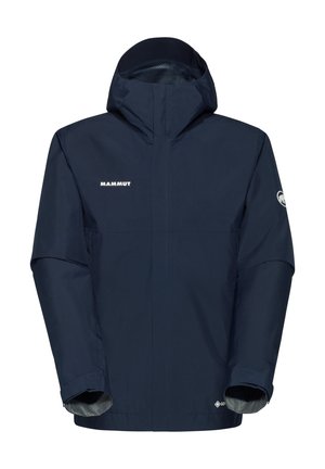 Veste imperméable navy avec capuche, col haut, fermeture éclair à l'avant et poignets élastiques. Présente le logo "Mammut" sur la poitrine.
