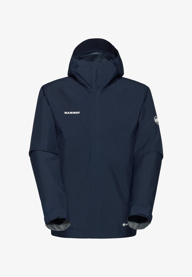 Marin vattentät jacka med huva, hög krage, dragkedja framtill och elastiska ärmmuddar. Har "Mammut"-logotypen på bröstet.