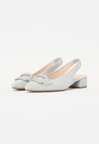 Chaussures slingback en daim gris clair avec un petit talon bloc, ornées d'un accent en nœud sur le bout pour une touche supplémentaire. Texture lisse dans l'ensemble.