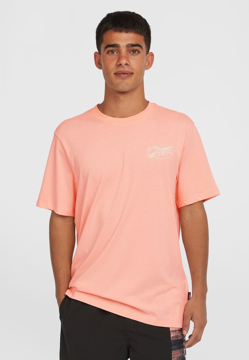 Pink cotton t-shirt with short sleeves, round neck, and front logo detail. The fabric appears smooth and lightweight.