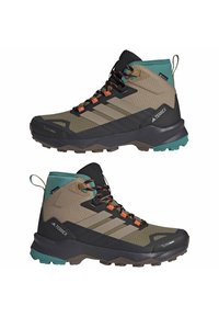 Brown and black mid-cut hiking boots with turquoise accents, textured upper, rubber sole, and orange laces. Features three signature stripes.