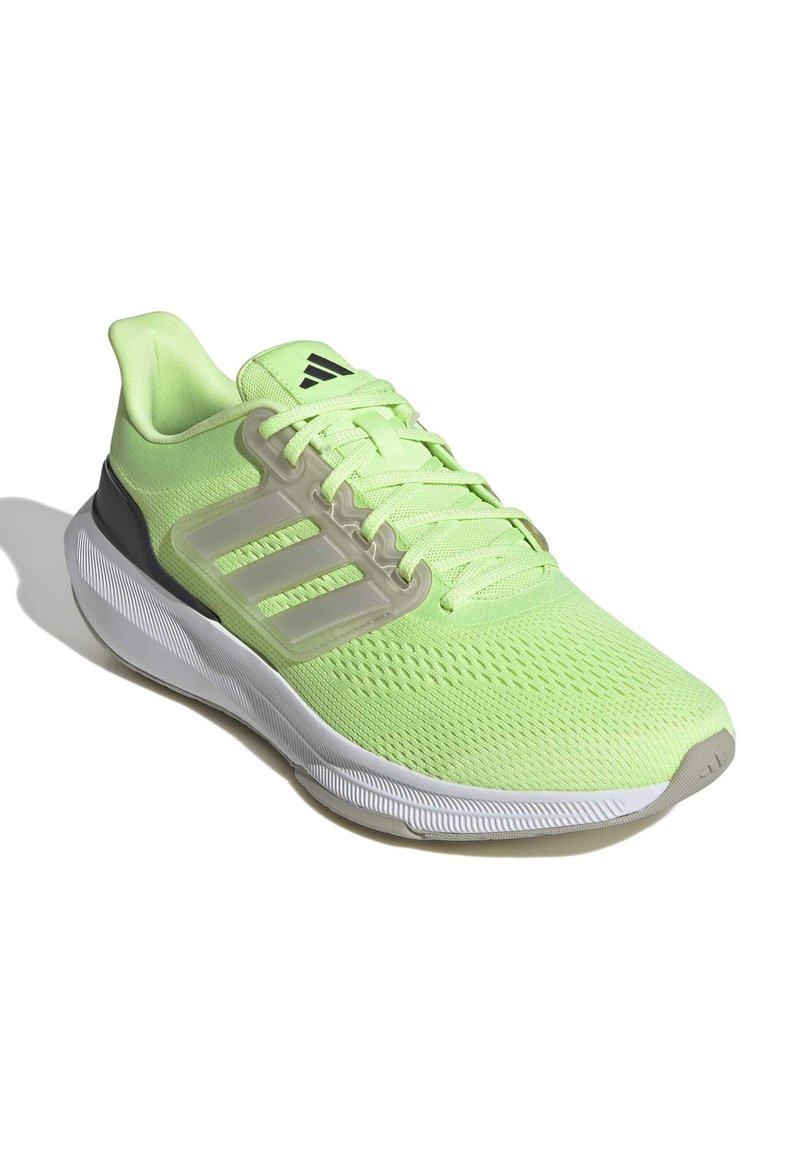 Zapatilla deportiva verde con parte superior de malla, tres franjas en el lateral, cuello acolchado, suela blanca y detalles texturizados a lo largo de la suela exterior.