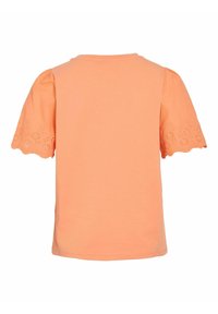 Camiseta de manga corta naranja con mangas abullonadas, con un borde festoneado y bordado de ojal. Tejido suave con un ajuste holgado.