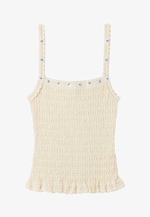 Top de tirantes sin mangas color crema con tirantes finos, tela texturizada fruncida, bordes en forma de ondas y pequeños adornos florales a lo largo del escote y los tirantes.