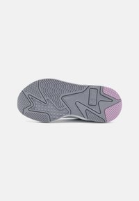 Suela de zapatilla atlética gris con patrones texturizados. Presenta un acento rosa en el borde exterior y un logotipo incrustado cerca del talón.