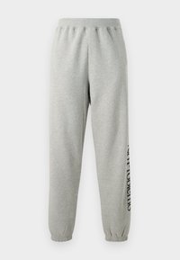 Pantalones de chándal grises hechos de una suave mezcla de algodón, con cintura y puños elásticos, y un detalle de texto impreso a lo largo del costado.