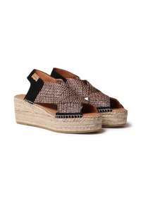 Espadrille sandale s tkanim gornjim dijelom u smeškastoj i crnoj boji, otvorenim prstima i platformom od jute konoplje. Imaju ukrštene trake i podstavljenu unutrašnjost.
