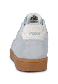 Light blue suede sneaker with a white textured heel tab, rubber sole, and "WOODEN" branding in light blue stitching.