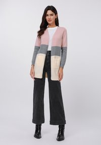 Color-blocked cardigan in pink, gray, and cream. Soft knit with open front design, featuring two front pockets and ribbed cuffs.