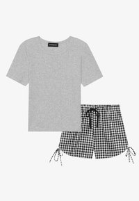 Gray cotton t-shirt with a round neckline, paired with black and white gingham shorts featuring adjustable ties at the hem.